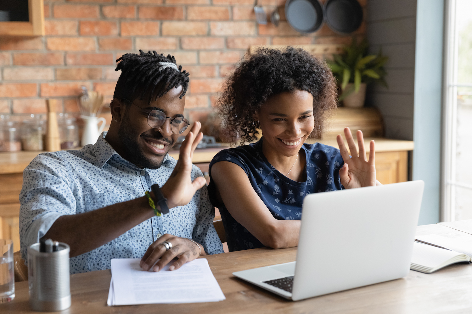 Young afro american couple contact lawyer by videocall wave hands